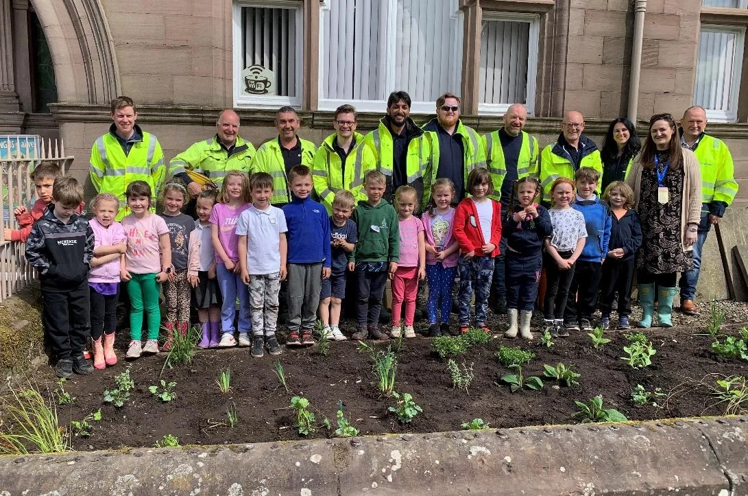 Project partners and school pupils outside Brechin Library Bee Beds
